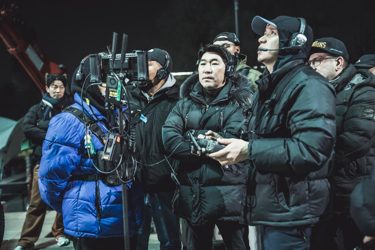 Ata Dala Production crew gathered at the monitor on a night shoot in Kazakhstan